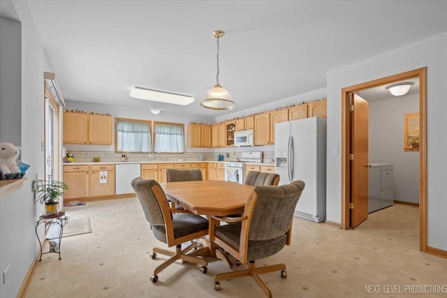 1705 Heatherstone Ave, Montgomery, IL 60538 - dining room with light floors, baseboards, and washer / dryer