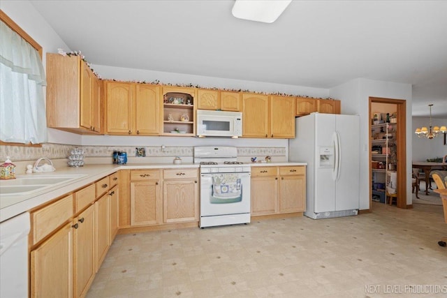 1705 Heatherstone Ave, Montgomery, IL 60538 - kitchen with white appliances, light flooring, a sink, light countertops, and a chandelier