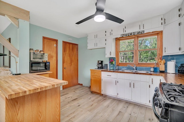 207 Redwood Ave, New Lenox, IL 60451 - kitchen featuring a sink, gas range oven, stainless steel microwave, ceiling fan, and white cabinetry