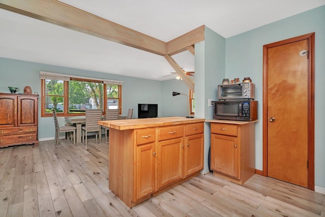 207 Redwood Ave, New Lenox, IL 60451 - kitchen with black microwave, light wood-style flooring, a peninsula, baseboards, and wood counters
