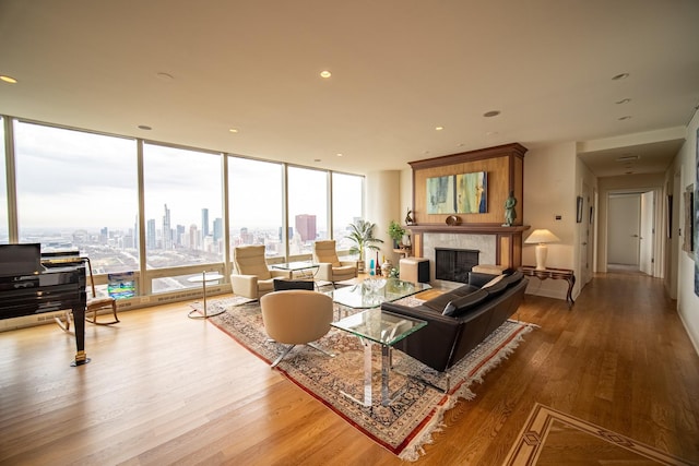 340 E Randolph St Unit 4703, Chicago, IL 60601 - living room featuring wood finished floors, a tiled fireplace, floor to ceiling windows, a view of skyline, and recessed lighting