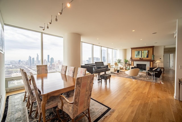 340 E Randolph St Unit 4703, Chicago, IL 60601 - dining area with light wood-style flooring, a fireplace, expansive windows, and a skyline view