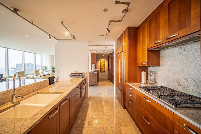 340 E Randolph St Unit 4703, Chicago, IL 60601 - kitchen featuring stainless steel gas cooktop, a sink, light stone countertops, and brown cabinets