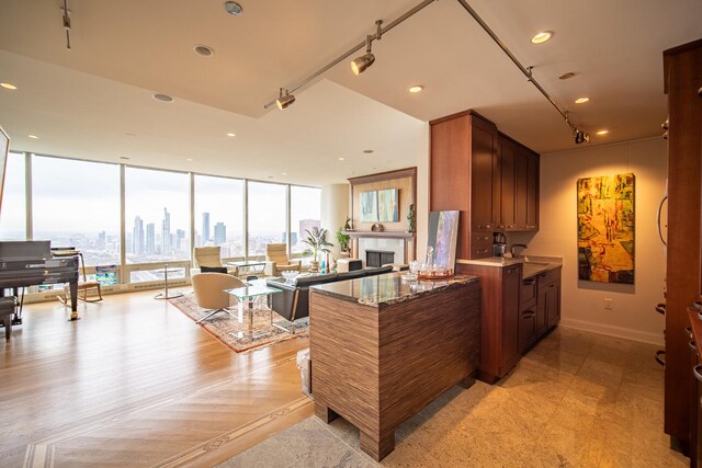 340 E Randolph St Unit 4703, Chicago, IL 60601 - kitchen featuring a fireplace, brown cabinetry, floor to ceiling windows, recessed lighting, and open floor plan
