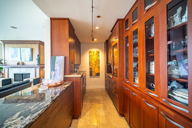340 E Randolph St Unit 4703, Chicago, IL 60601 - kitchen featuring brown cabinetry, recessed lighting, baseboards, and glass insert cabinets