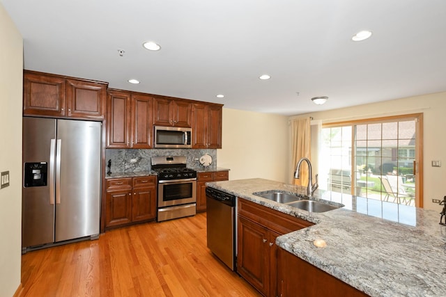 9403 Saratoga Ct, Hickory Hills, IL 60457 - kitchen with appliances with stainless steel finishes, a sink, light wood-type flooring, light stone counters, and decorative backsplash