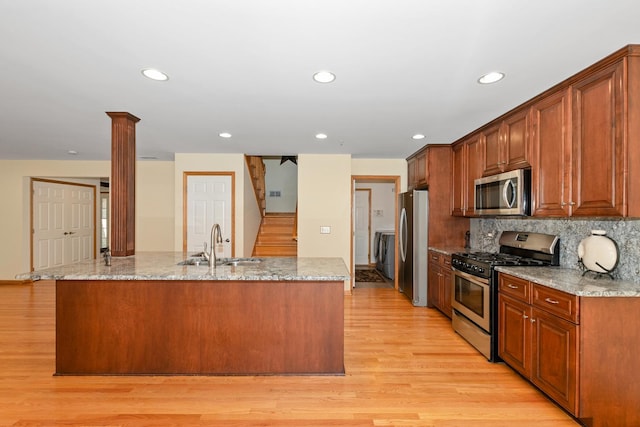 9403 Saratoga Ct, Hickory Hills, IL 60457 - kitchen featuring stainless steel appliances, a sink, light wood finished floors, recessed lighting, and decorative columns