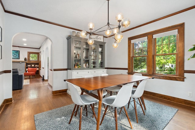 47 S Julian St, Naperville, IL 60540 - dining room with arched walkways, crown molding, hardwood / wood-style floors, a chandelier, and baseboards