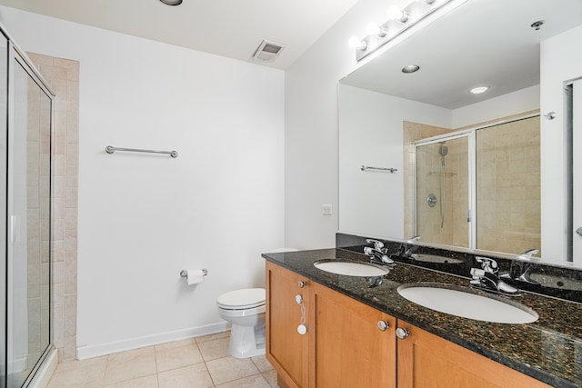 3450 S Halsted St Unit 308, Chicago, IL 60608 - full bathroom with tile patterned floors, double vanity, a shower stall, and toilet