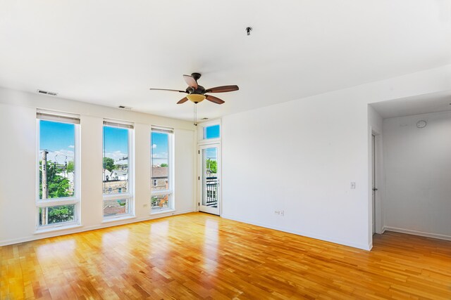3450 S Halsted St Unit 308, Chicago, IL 60608 - spare room featuring light wood-style floors, ceiling fan, and baseboards