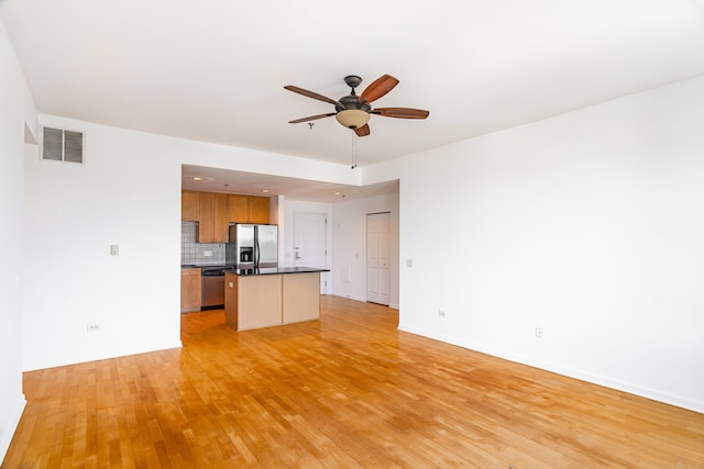3450 S Halsted St Unit 308, Chicago, IL 60608 - kitchen featuring appliances with stainless steel finishes, open floor plan, light wood finished floors, and a ceiling fan