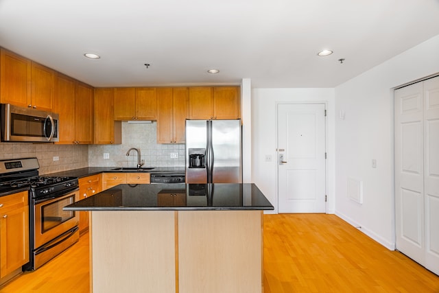 3450 S Halsted St Unit 308, Chicago, IL 60608 - kitchen with appliances with stainless steel finishes, a sink, light wood-type flooring, decorative backsplash, and dark stone countertops