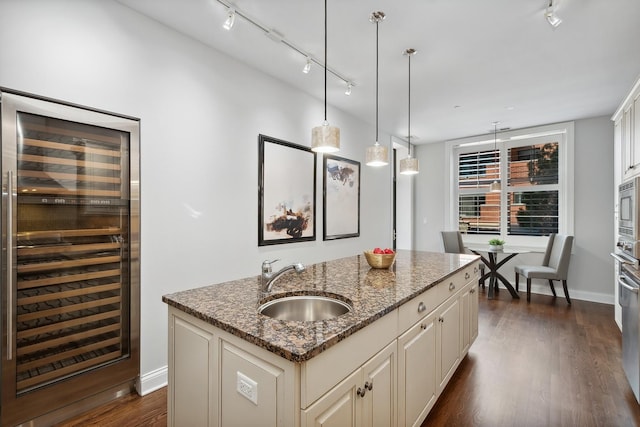 30 W Erie St Unit 402, Chicago, IL 60654 - kitchen with beverage cooler, track lighting, a sink, a center island with sink, and dark wood finished floors