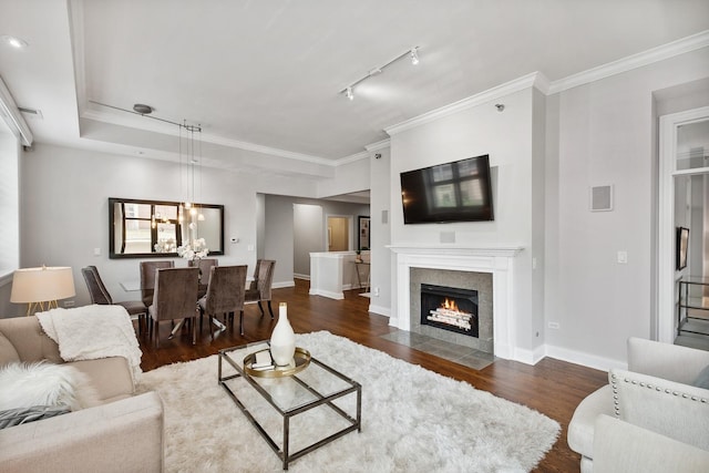 30 W Erie St Unit 402, Chicago, IL 60654 - living room featuring dark wood-type flooring, a chandelier, baseboards, a fireplace with flush hearth, and ornamental molding