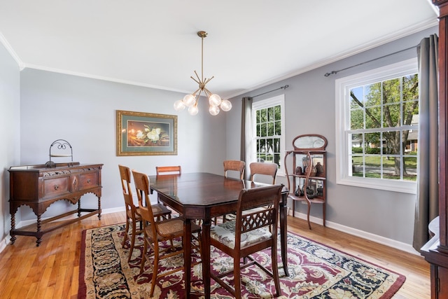 25W303 Gunston Ave, Naperville, IL 60540 - dining area featuring crown molding, light wood-style floors, baseboards, and a chandelier
