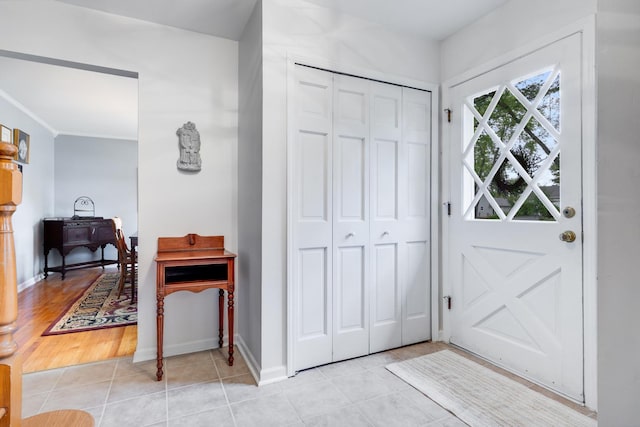 25W303 Gunston Ave, Naperville, IL 60540 - foyer with light tile patterned floors, baseboards, and crown molding