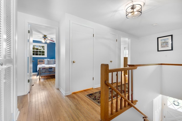 25W303 Gunston Ave, Naperville, IL 60540 - corridor featuring an upstairs landing, light wood-style flooring, and baseboards