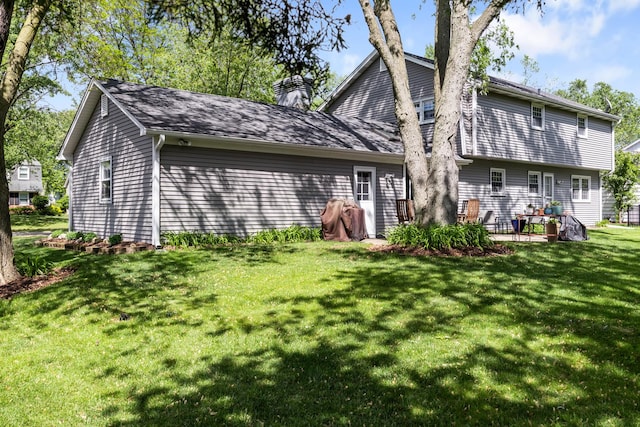 25W303 Gunston Ave, Naperville, IL 60540 - back of house with a chimney and a yard