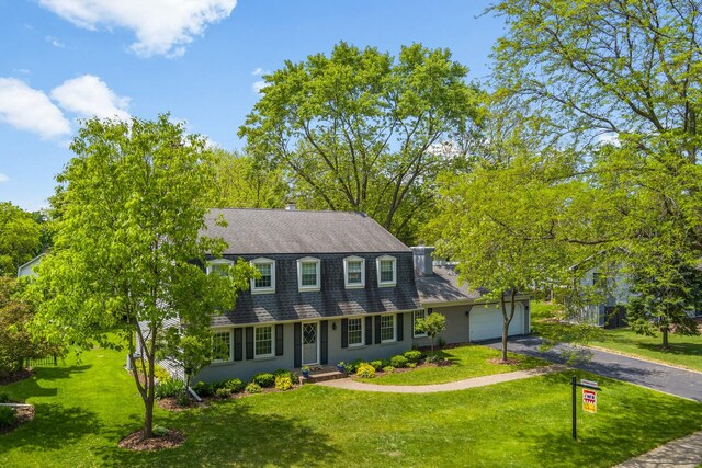 25W303 Gunston Ave, Naperville, IL 60540 - colonial inspired home with driveway, a shingled roof, a garage, and a front lawn