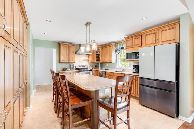 25W303 Gunston Ave, Naperville, IL 60540 - kitchen featuring stainless steel appliances, a sink, wall chimney range hood, light stone counters, and decorative backsplash