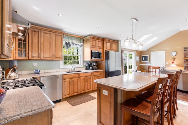 25W303 Gunston Ave, Naperville, IL 60540 - kitchen featuring stainless steel appliances, a sink, healthy amount of natural light, lofted ceiling, and a center island