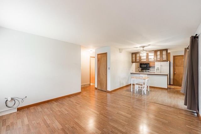 1532 E Stonehenge Drive -, Sycamore, IL 60178 - unfurnished living room featuring light wood-style floors and ceiling fan