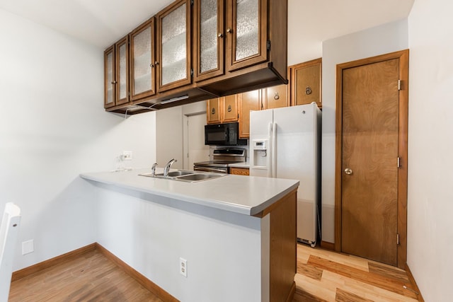 1532 E Stonehenge Drive -, Sycamore, IL 60178 - kitchen featuring black microwave, stainless steel range with electric stovetop, white fridge with ice dispenser, light wood-style flooring, and light countertops