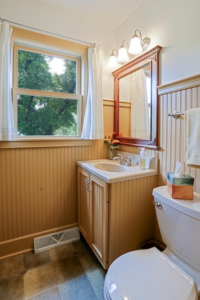 611 S 10th Ave, Saint Charles, IL 60174 - bathroom featuring vanity, wainscoting, and wooden walls