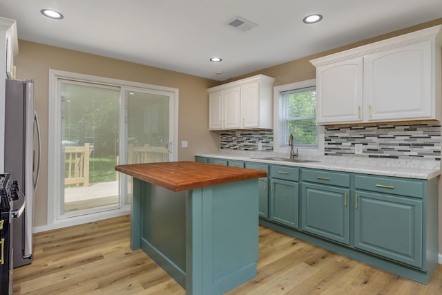 3708 W 162nd Pl, Markham, IL 60428 - kitchen with butcher block countertops, white cabinets, decorative backsplash, light wood-style flooring, and recessed lighting