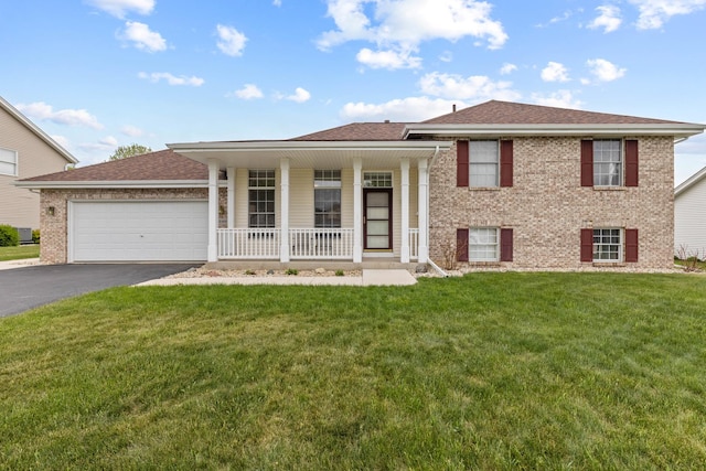 12169 Ayrshire Ln, Loves Park, IL 61111 - split level home featuring a porch, asphalt driveway, brick siding, a front yard, and a garage