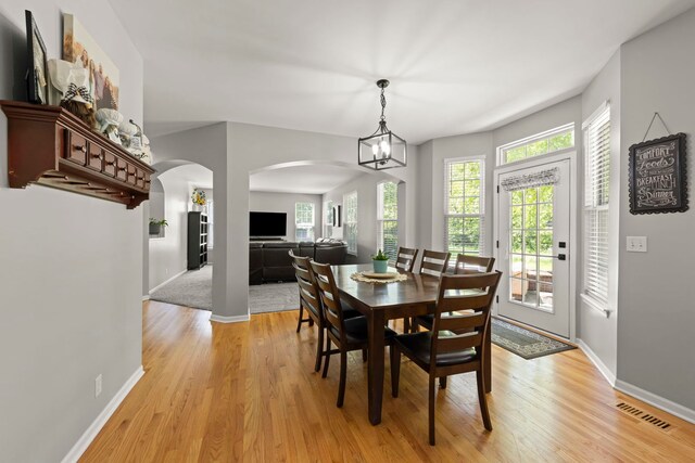 1284 Mcdole Dr, Sugar Grove, IL 60554 - dining area featuring arched walkways, light wood-type flooring, and baseboards