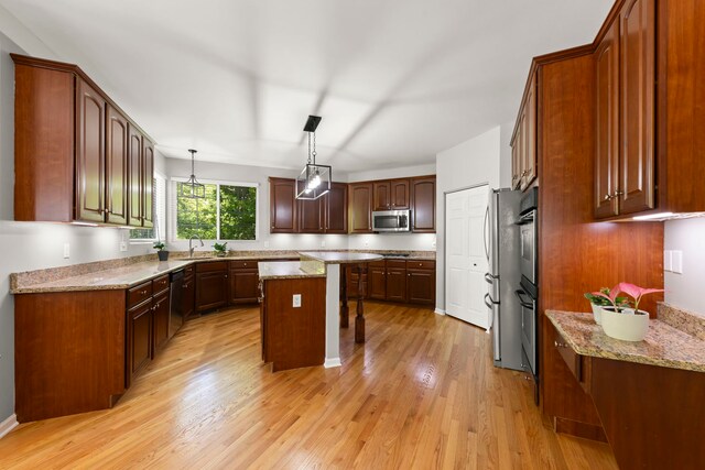1284 Mcdole Dr, Sugar Grove, IL 60554 - kitchen with black appliances, a center island, light wood-type flooring, and light stone counters