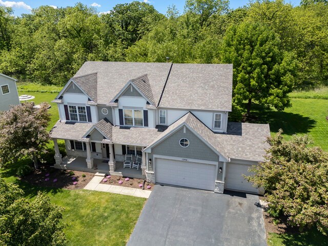 1284 Mcdole Dr, Sugar Grove, IL 60554 - view of front facade with covered porch, an attached garage, a front yard, and driveway