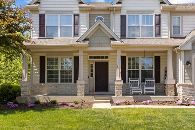 1284 Mcdole Dr, Sugar Grove, IL 60554 - craftsman house featuring covered porch, a front lawn, roof with shingles, and stone siding