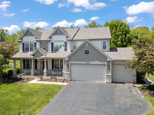 1284 Mcdole Dr, Sugar Grove, IL 60554 - view of front of house featuring driveway, a front yard, a garage, a porch, and stone siding