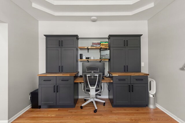 1284 Mcdole Dr, Sugar Grove, IL 60554 - office space with light wood-style floors, built in desk, a tray ceiling, and baseboards