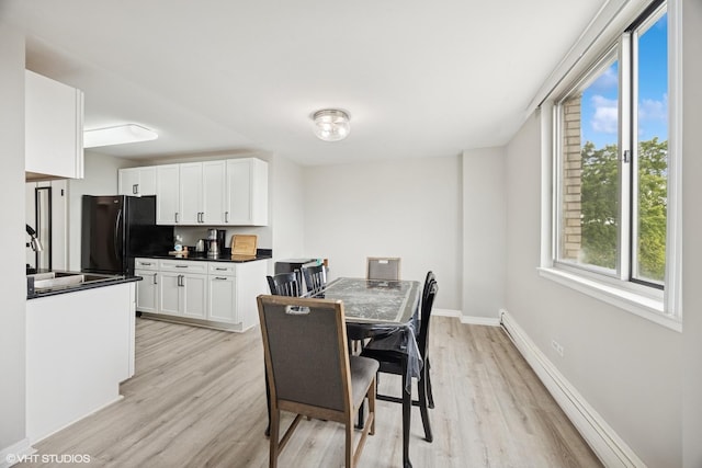 20 N Tower Rd Unit 3G, Oak Brook, IL 60523 - dining space with light wood-style flooring, baseboards, and baseboard heating