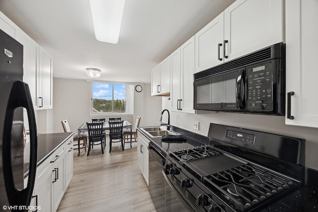 20 N Tower Rd Unit 3G, Oak Brook, IL 60523 - kitchen with black appliances, a sink, light wood-style flooring, and white cabinetry