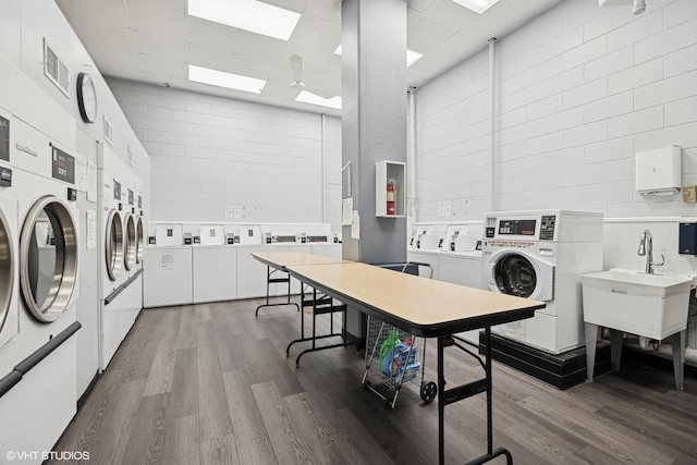20 N Tower Rd Unit 3G, Oak Brook, IL 60523 - communal laundry room with washer and dryer, stacked washer and clothes dryer, dark wood-type flooring, a skylight, and a high ceiling