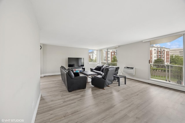 20 N Tower Rd Unit 3G, Oak Brook, IL 60523 - living area featuring wood finished floors, healthy amount of natural light, baseboards, and an AC wall unit