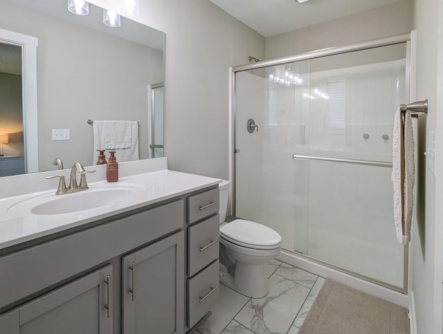 1785 Condor Dr, Manteno, IL 60950 - bathroom featuring marble look tiles, a stall shower, vanity, and toilet