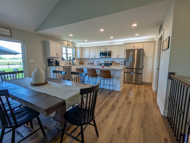 1785 Condor Dr, Manteno, IL 60950 - dining area with recessed lighting, light wood-style floors, and vaulted ceiling