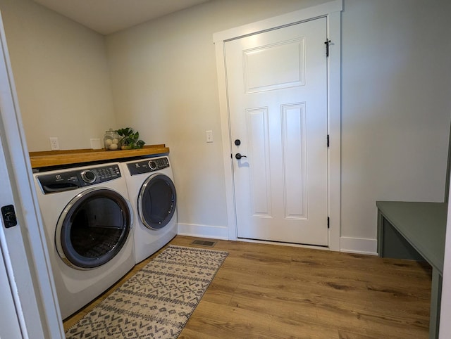 1785 Condor Dr, Manteno, IL 60950 - washroom featuring washing machine and dryer, wood finished floors, and baseboards