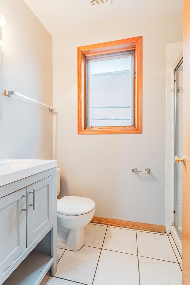 2413 W Taylor St, Chicago, IL 60612 - bathroom featuring vanity, toilet, a shower stall, baseboards, and tile patterned flooring