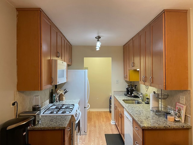 1188 Royal Glen Dr Unit 211, Glen Ellyn, IL 60137 - kitchen featuring white appliances, a sink, light wood-type flooring, brown cabinets, and tasteful backsplash
