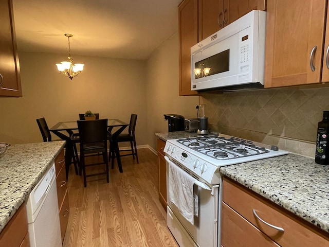 1188 Royal Glen Dr Unit 211, Glen Ellyn, IL 60137 - kitchen featuring white appliances, light wood-type flooring, brown cabinets, decorative backsplash, and a chandelier