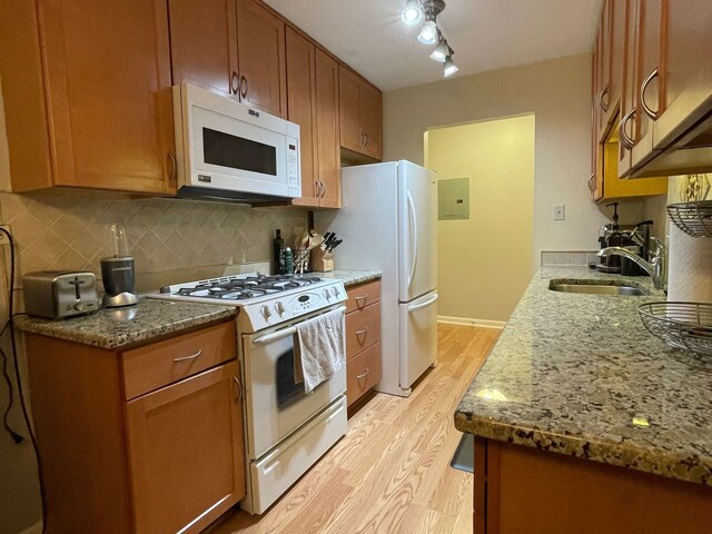 1188 Royal Glen Dr Unit 211, Glen Ellyn, IL 60137 - kitchen with white appliances, a sink, light wood-type flooring, tasteful backsplash, and brown cabinets