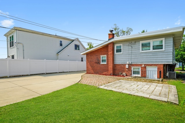 473 W Verret St, Elmhurst, IL 60126 - rear view of house featuring a chimney, a patio area, brick siding, and central AC