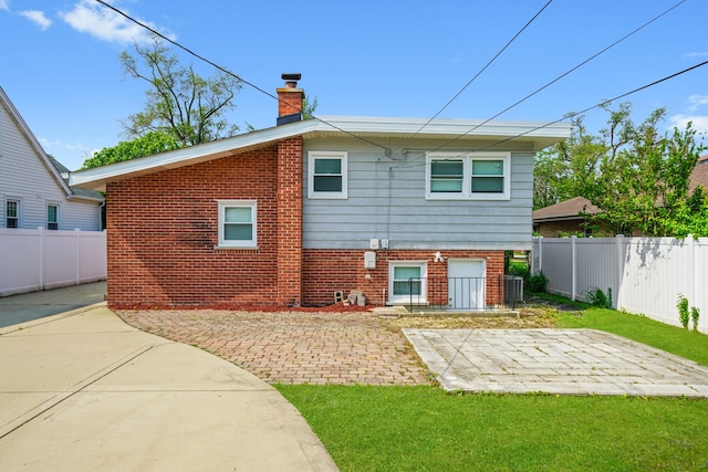 473 W Verret St, Elmhurst, IL 60126 - rear view of house featuring a patio area, a chimney, and brick siding