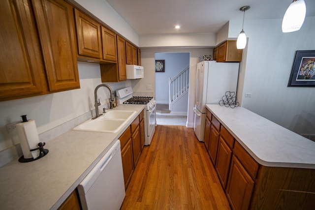 7902 160th St, Tinley Park, IL 60477 - kitchen with white appliances, a sink, brown cabinetry, light wood finished floors, and light countertops